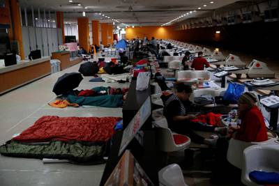 Spectators who evacuate from Typhoon Hagibis, gather at a makeshift accommodation for spectators of Formula One Japanese Grand Prix at Suzuka Circuit in Suzuka, central Japan. Reuters