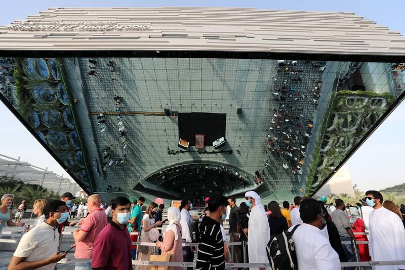 Crowds queuing outside the Saudi Arabia pavilion are reflected in its exterior. Chris Whiteoak / The National