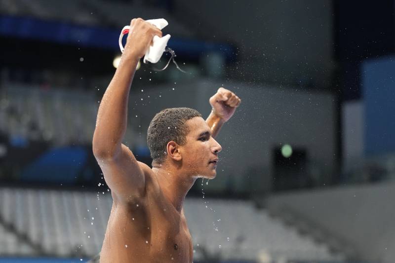 Ahmed Hafnaoui of Team Tunisia celebrates after winning the gold medal in the Men's 400m Freestyle Final on day two of the Tokyo 2020 Olympic Games.