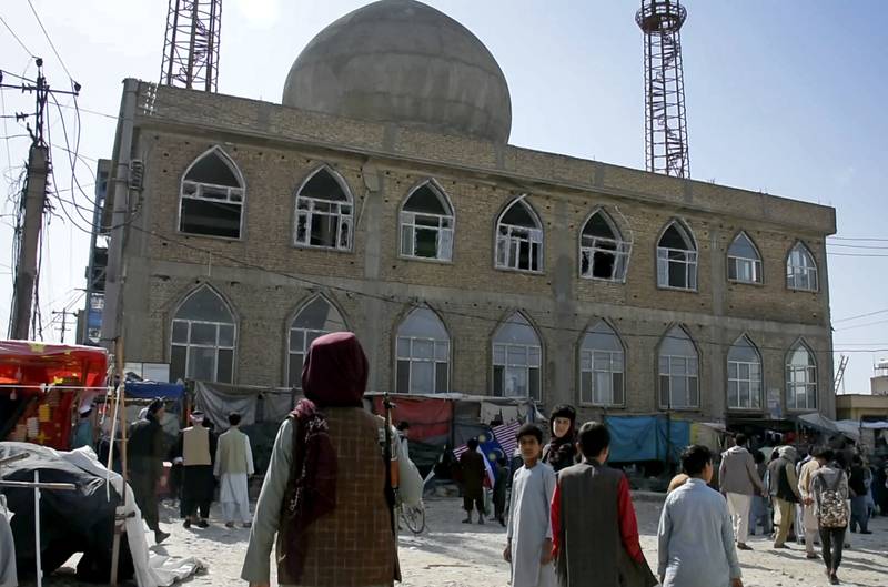 A Taliban fighter stands guard at the site of a bomb explosion inside a mosque in Mazar-e-Sharif province, Afghanistan, on April 21. AP