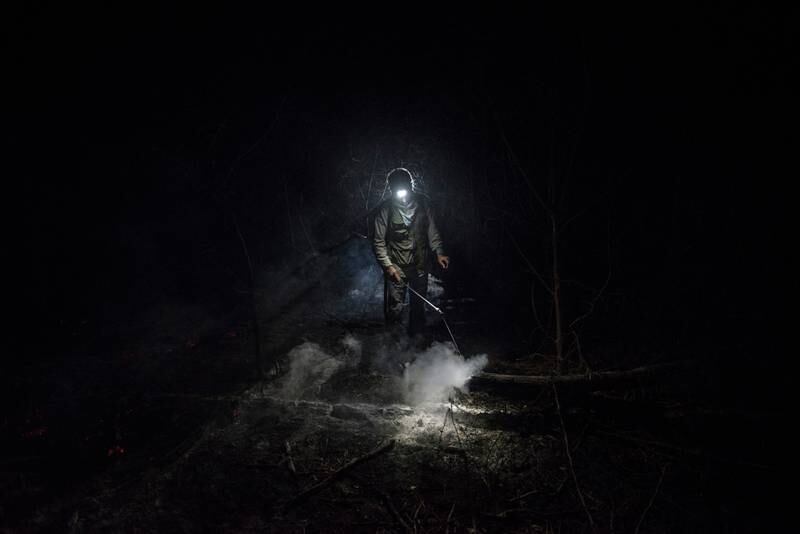 Honourable Mention, Climate, Marcelo Perez del Carpio, Bolivia. A forest firefighter walks through thick smoke.