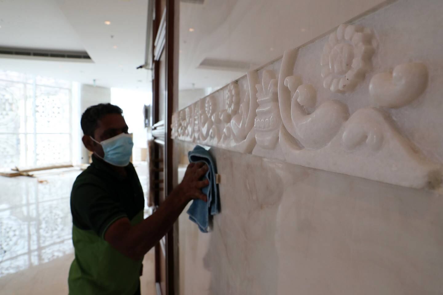 A worker polishes some of the hand-carved features in the temple. Pawan Singh / The National