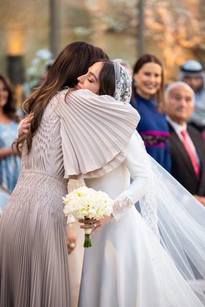 Princess Iman hugs her mother, Queen Rania. AFP 