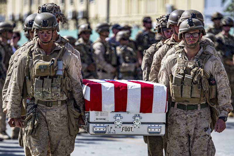 Caskets carrying the remains of soldiers killed at Hamid Karzai International Airport in Kabul are placed on board an aircraft for their return to the US. AP