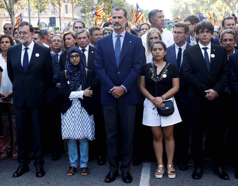 Spain's King Felipe (C), Prime Minister Mariano Rajoy (L) and Catalan regional president Carles Puigdemont (R) take part in a march of unity after the attacks last week, in Barcelona, Spain, August 26, 2017. REUTERS/Juan Medina     TPX IMAGES OF THE DAY