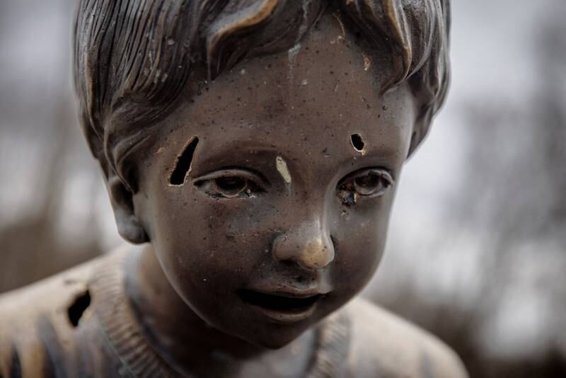 Shrapnel marks are seen on the statue of a child after shelling that hit the Gorky amusement park, in Kharkiv. Reuters