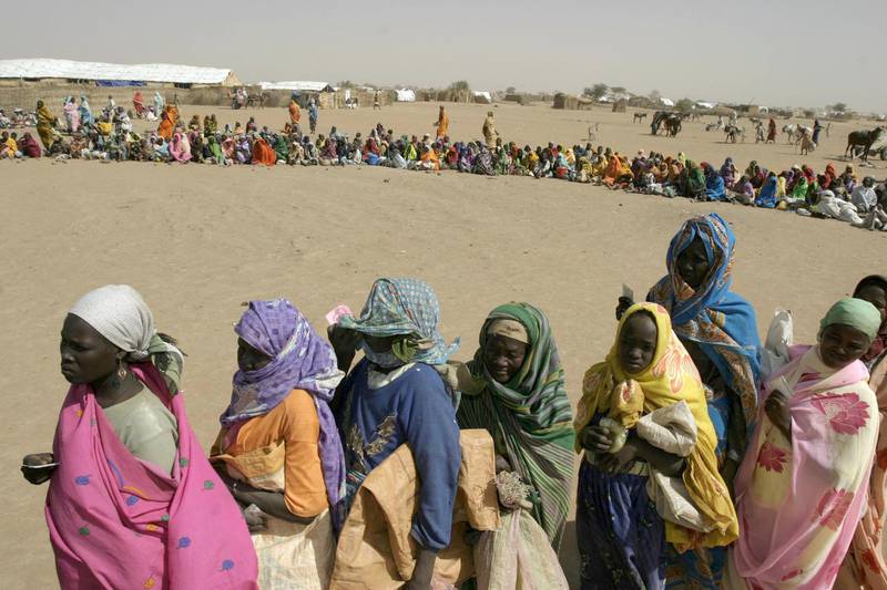 TO GO WITH STORY BY GUILLAUME LAVALLEE
(FILES) Internally-displaced Sudanese wait to receive food supplies from from the World Food Program in Kalma Camp, near Nyala town in Sudan's southern Darfur region on January 10, 2005. AFP PHOTO/JOSE CENDON (Photo by JOSE CENDON / AFP FILES / AFP)