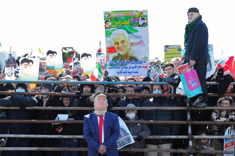 A protester pretends to use a shoe to hit a man impersonating U.S president Donald Trump, during an annual rally at Azadi (Freedom) Square celebrating 41st anniversary of Islamic Revolution, in Tehran, Iran, Tuesday, Feb. 11, 2020. Iranians took to the streets of Tehran and other cities and towns across the country on Tuesday for rallies and nationwide celebrations marking the anniversary of the 1979 Islamic Revolution when followers of Ayatollah Khomeini ousted U.S.-backed Shah Mohammad Reza Pahlavi. (AP Photo/Ebrahim Noroozi)