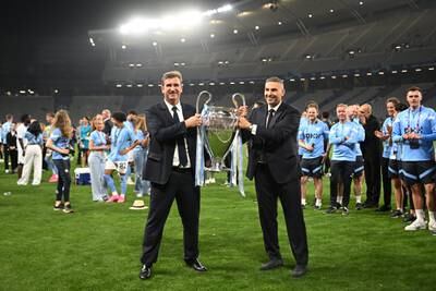 Khaldoon Al Mubarak, right, and Ferran Soriano celebrate with the European Cup on the pitch. AFP