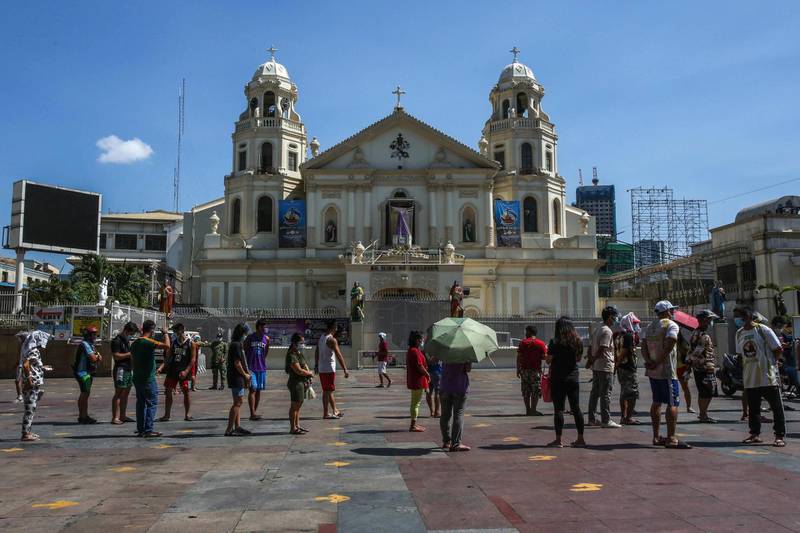 Roman Catholic devotees gather outside Quiapo Church in Manila for a Good Friday service on April 2, 2021, after the government imposed strict lockdowns to cope with a surge in Covid-19 infections. AFP