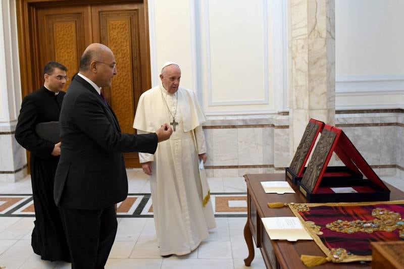 Pope Francis receives gifts from Iraqi President Barham Salih, two stone carvings by the late Iraqi artist Mohammed Ghani Hikmat, and a hand embroidered cross in gold thread and semi precious stones with a head cap from Kurdistan.  Office of the President