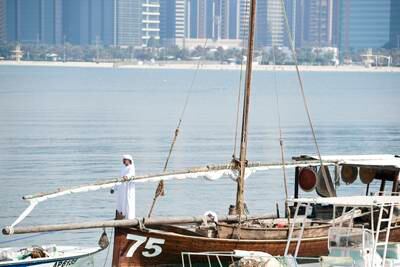 Dhows moored at the Heritage Village in Abu Dhabi. Khushnum Bhandari / The National
