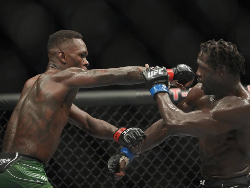 Israel Adesanya throws a punch at Jared Cannonier during their middleweight title fight at UFC 276. Reuters