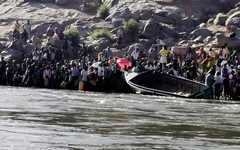 Ethiopians who fled the ongoing fighting in Tigray region prepare to cross the Setit River on the Sudan-Ethiopia border in Hamdait village in eastern Kassala state, Sudan.  Reuters
