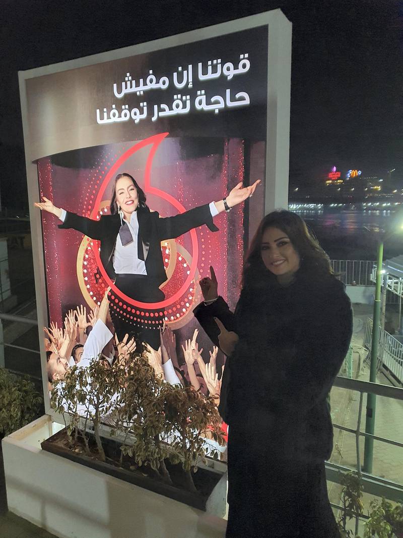 Egyptian actress Bushra points to an advertisement of the Vodafone TV commercial starring 'Fawazeer Ramadan' star Sherihan. Photo courtesy: Bushra