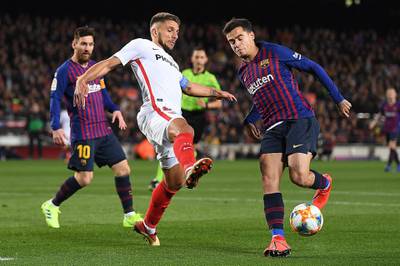 Barcelona's Philippe Coutinho is challenged by Sevilla's Carrico. Getty Images