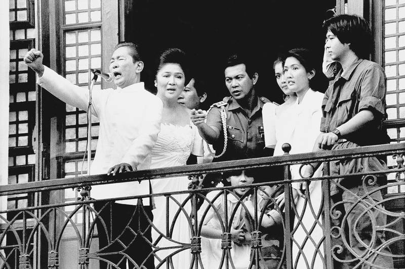Marcos, Imelda and Ferdinand Marcos Jr, far right, stand on the balcony of Malacanang Palace on February 25, 1986, right after Marcos took the oath of office. AP