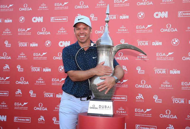 England's Paul Casey celebrates with the trophy after winning in Dubai. Getty