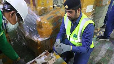 Dubai Customs officials inspect a consignment of goods, searching for counterfeit products. Wam