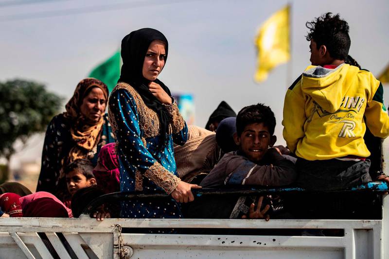 (FILES) In this file photo taken on October 11, 2019 displaced Syrians sit in the back of a pick up truck as Arab and Kurdish civilians flee amid Turkey's military assault on Kurdish-controlled areas in northeastern Syria, on October 11, 2019 in the town of Tal Tamr in the countryside of Syria's northeastern Hasakeh province. The Turkish military offensive in Syria has displaced at least 160,000 civilians, the UN secretary general said on October 14, 2019 in a statement urging an "immediate de-escalation." Secretary-General Antonio Guterres "is gravely concerned over the military developments in northeast Syria," the statement said. It said Guterres was urging "all parties to resolve their concerns through peaceful means," adding that "civilians not taking part in hostilities must be protected at all times."
 / AFP / Delil SOULEIMAN

