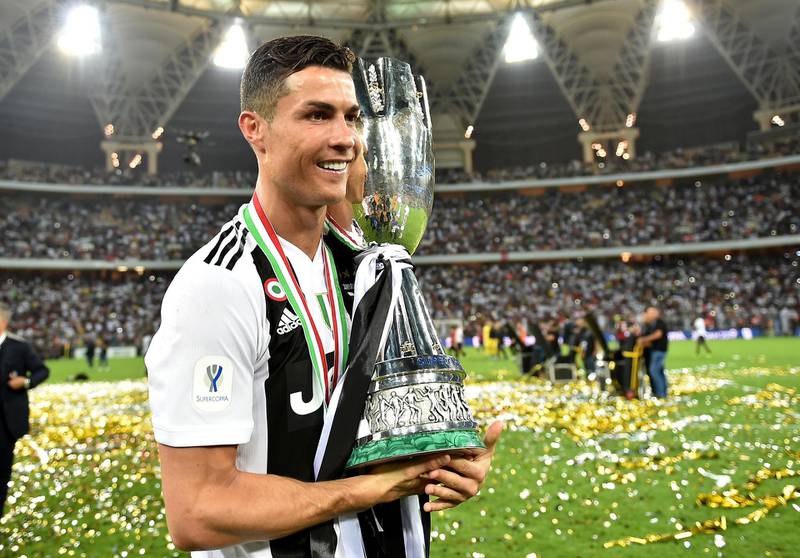 Cristiano Ronaldo celebrates with the Italian Super Cup after his side beat AC Milan 1-0 in Jeddah, Saudi Arabia. EPA