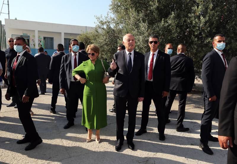 Mr Saied leaves the polling station with his wife. Tunisia is holding a referendum on a new draft constitution proposed by the president to replace the 2014 constitution. EPA