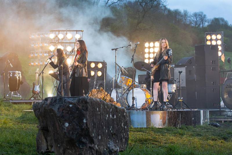 GLASTONBURY, UNITED KINGDOM - MAY 21: In this image released on May 21st, HAIM perform in the Stone Circle as part of the Glastonbury Festival Global Livestream ‚ÄúLive at Worthy Farm‚Äù at Worthy Farm, Pilton on May 16, 2021 in Glastonbury, England. The five hour special production is being filmed across Glastonbury Festivals Worthy Farm site with artists including Coldplay, Damon Albarn, HAIM, IDLES, Jorja Smith, Kano, Michael Kiwanuka, Wolf Alice and DJ Honey Dijon with Roisin Murphy. The global livestream is being broadcast on Saturday May 22 with encore screenings on Sunday May 23. (Photo by Anna Barclay for Glastonbury Festival via Getty Images)