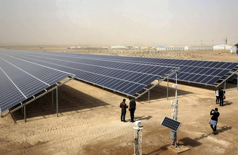 A general view shows part of a new 15 million euro solar plant, funded by the German government, that emits some 12.9 megawatts during its official inauguration at the Zaatari refugee camp on November 13, 2017. 
Some 80,000 Syrian refugees living in the Zaatari camp will have access to 14 hours of electricity per day instead of eight hours, thanks to the opening of the new solar power station. / AFP PHOTO / KHALIL MAZRAAWI