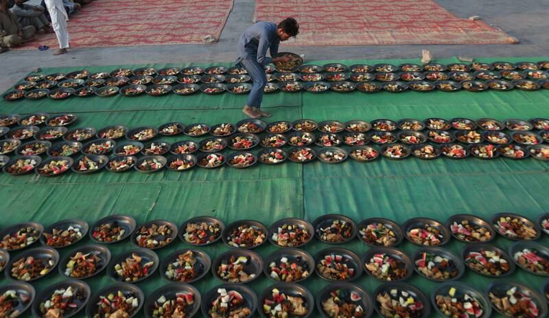 A Muslim places food for people to break their fast on a roadside in Karachi, Pakistan. EPA