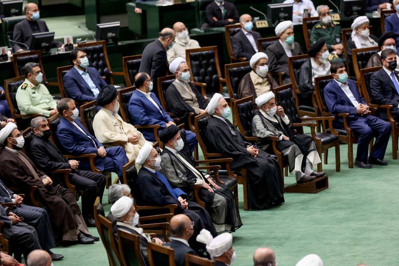 Former Iranian President Hassan Rouhani and Iran's new President Ebrahim Raisi attend the swearing-in ceremony at the parliament in Tehran, Iran