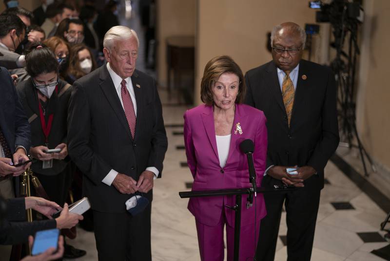 Speaker of the House Nancy Pelosi, flanked by House Majority Leader Steny Hoyer and House Majority Whip James Clyburn, updates reporters on the vote to advance President Joe Biden's domestic policy package. AP