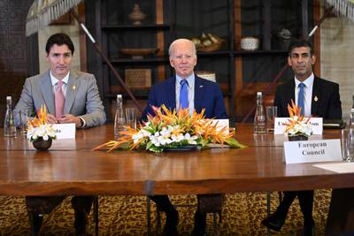 Mr Trudeau, Mr Biden and Mr Sunak at the meeting. AFP