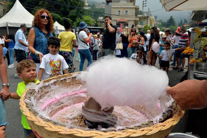 A vendor makes cotton candy for a customer during Cherry Day in the village of Hammana, southeast of Beirut, Lebanon.  EPA