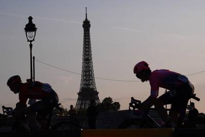 Cyclists rise past the Eiffel Tower during the final stage on July 28, 2019.  AFP