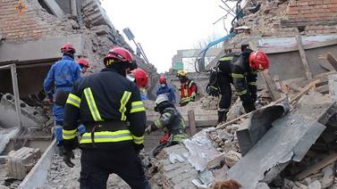 Emergency workers in the rubble of a civilian building after an air strike in Rzhyshchiv, Ukraine. Reuters