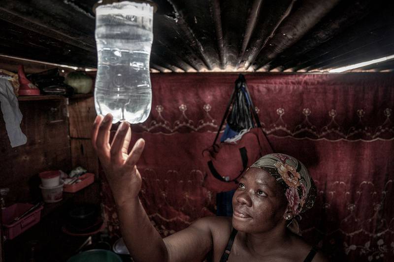 A plastic bottle used to provide light in her shack in an informal settlement, in Centurion, South Africa. Scheduled blackouts have burdened Africa's most industrialised economy for years. AFP

