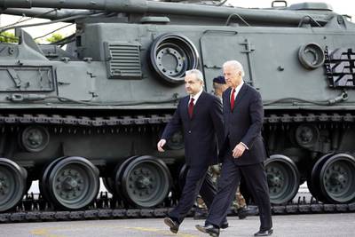 US Vice President Joe Biden (R) and Lebanese Defence Minister Elias Murr walk past a US-made tank during a ceremony at the Rafiq Hariri international airport in Beirut on May 22, 2009. Biden said that Washington will determine its aid to Lebanon based on the outcome of a tightly contested legislative election that the Islamist group Hezbollah could win. He wrapped up his seven-hour visit at Beirut airport, standing before an array of military equipment, including tanks, armoured personnel carriers and helicopters that he said are part of more than half a billion dollars in US military assistance to Lebanon since 2005. AFP PHOTO/JOSEPH BARRAK (Photo by JOSEPH BARRAK / AFP)
