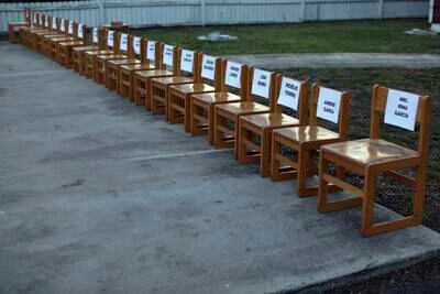 Twenty-one empty chairs are seen outside of a daycare center as a memorial for the victims. AP Photo 