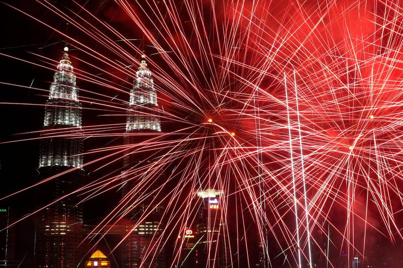 Fireworks illuminate the night sky over the Petronas Towers landmark during New Year's Day celebrations in Kuala Lumpur, Malaysia.  EPA