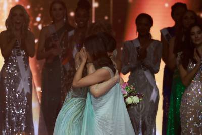 Miss Paraguay Nadia Ferreira, left, embraces Miss India Harnaaz Sandhu after the winner is announced. AFP