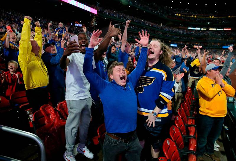 Marco Nettles, left, Tim Goodwin, center, and Grant Cawley, celebrate the St. Louis Blues' victory in Game 7 of the NHL hockey Stanley Cup Final, during a watch party at Busch Stadium in St. Louis.  AP