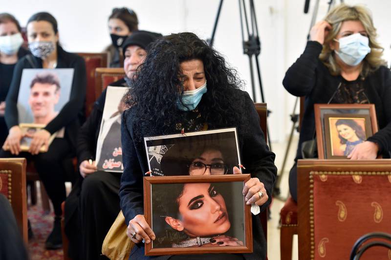 A woman reacts as she carries a picture of her daughter one of the victims of Beirut port explosion during the ceremony on the occasion of Mother's Day in Beirut, Lebanon. EPA