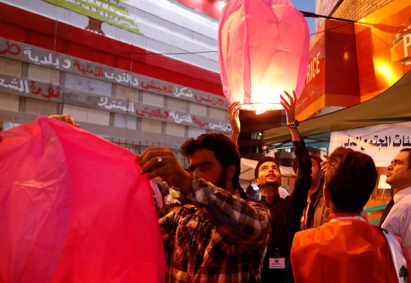 A demonstrator releases a sky lantern during a protest in Tripoli. REUTERS
