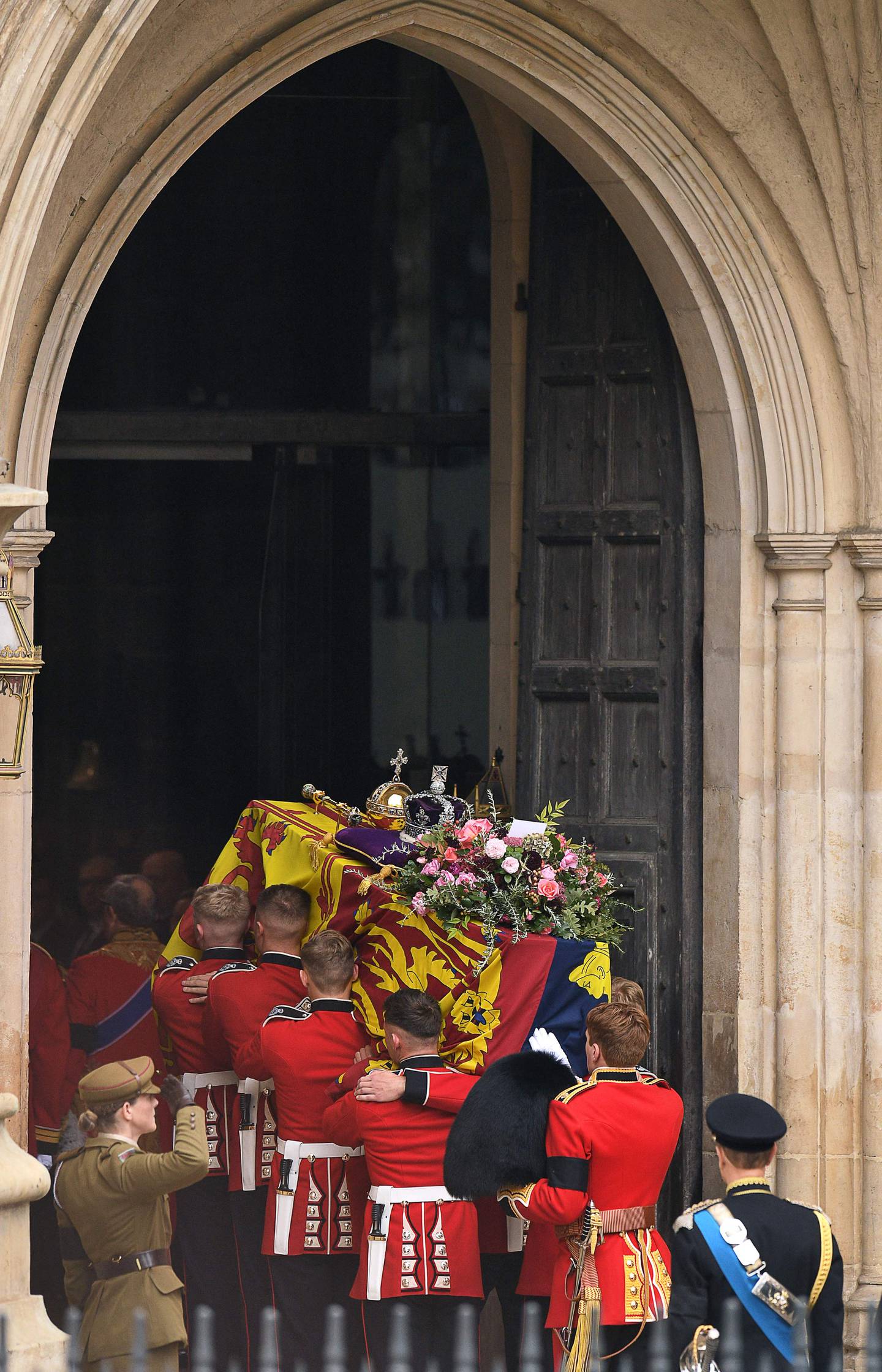 The coffin of Queen Elizabeth II, draped in the Royal Standard and adorned with the Imperial State Crown and the Sovereign's Orb and Sceptre, being carried into Westminster Abbey for the state funeral. AFP