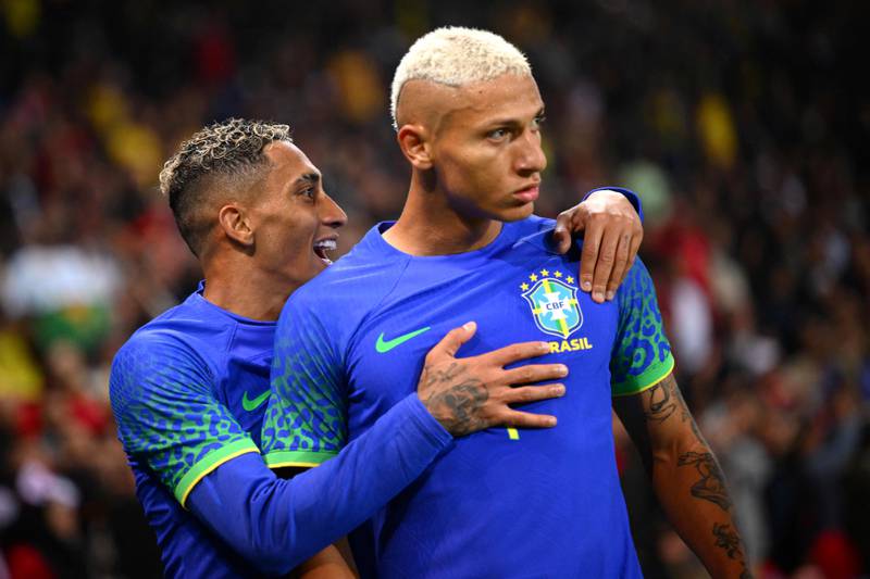 Brazil's forward Richarlison (R) celebrates after scoring his team's second goal during the friendly football match between Brazil and Tunisia at the Parc des Princes in Paris on September 27, 2022.  (Photo by Anne-Christine POUJOULAT  /  AFP)