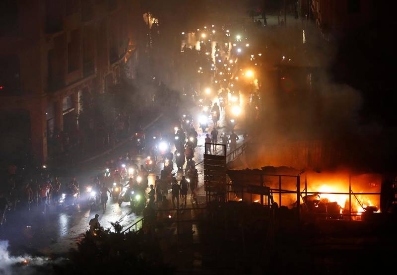 Protesters arrive on two-wheelers at a square near the government palace in Beirut. AP Photo