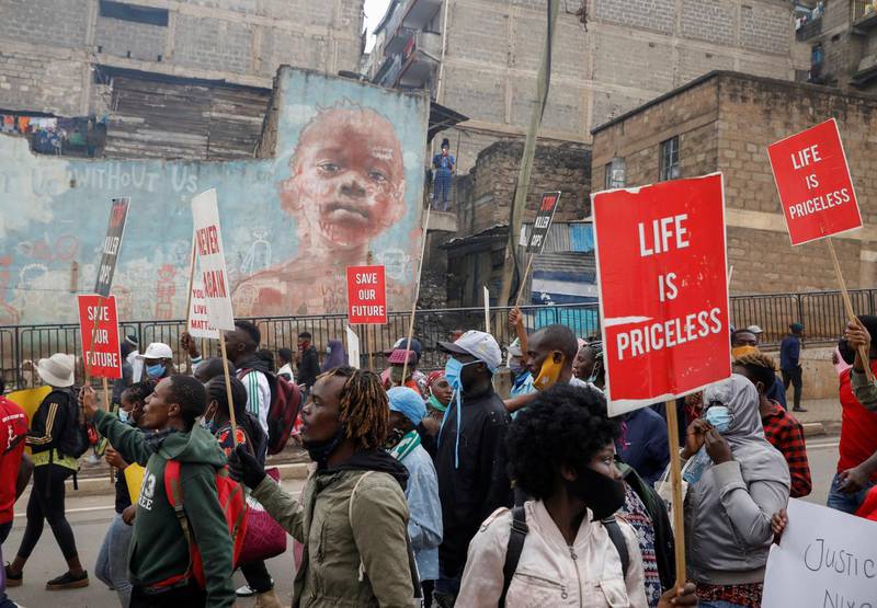 Protesters hold placards during a demonstration against police killings and brutality, in the Mathare slum in Nairobi, Kenya. REUTERS