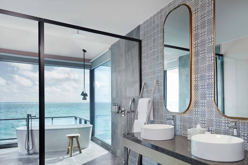 Bathrooms feature his and hers sink, a free-standing bath and ocean views.
