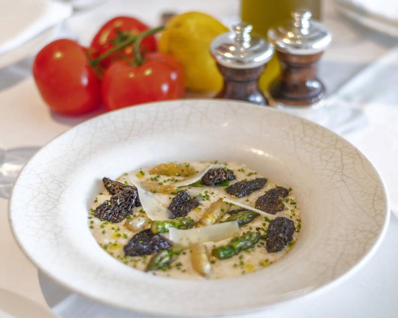 <p>Asparagus and morels risotto at&nbsp;La Petite Maison: made with non-alcoholic white wine, mascarpone, garlic, shallots and garnished with green and white asparagus, morel mushrooms, and shaved Parmesan&nbsp;</p>
