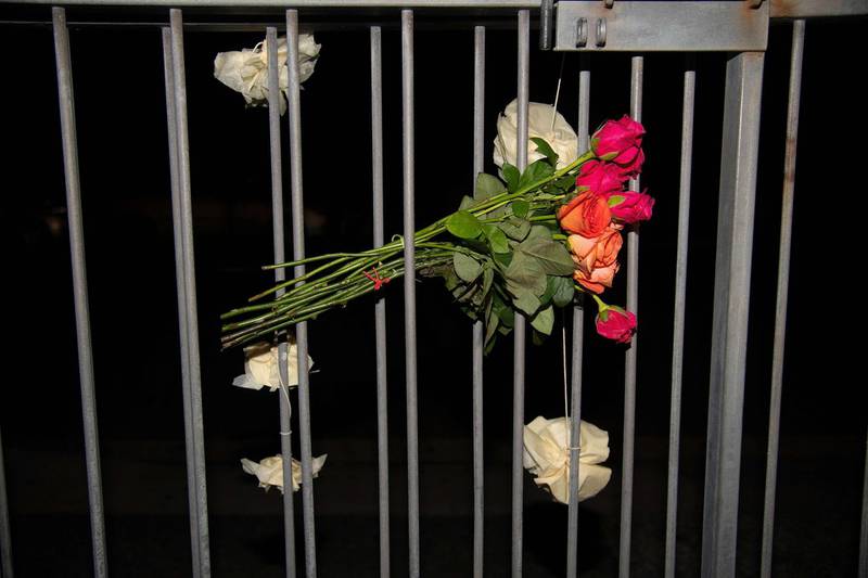 Flowers are tied to the fence on the front of the Wellington Masjid mosque in Kilbirnie . AFP